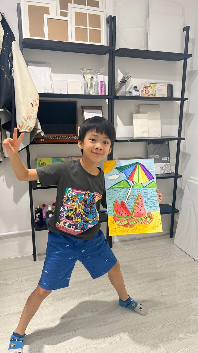 Young artist showing painting created at ArtVenture art class