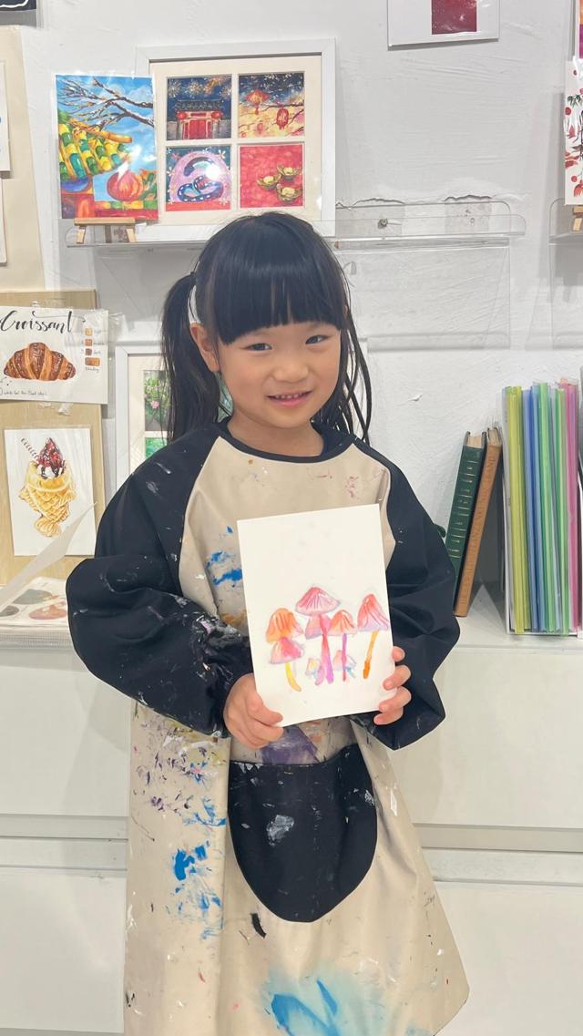 Child holding completed artwork at ArtVenture studio
